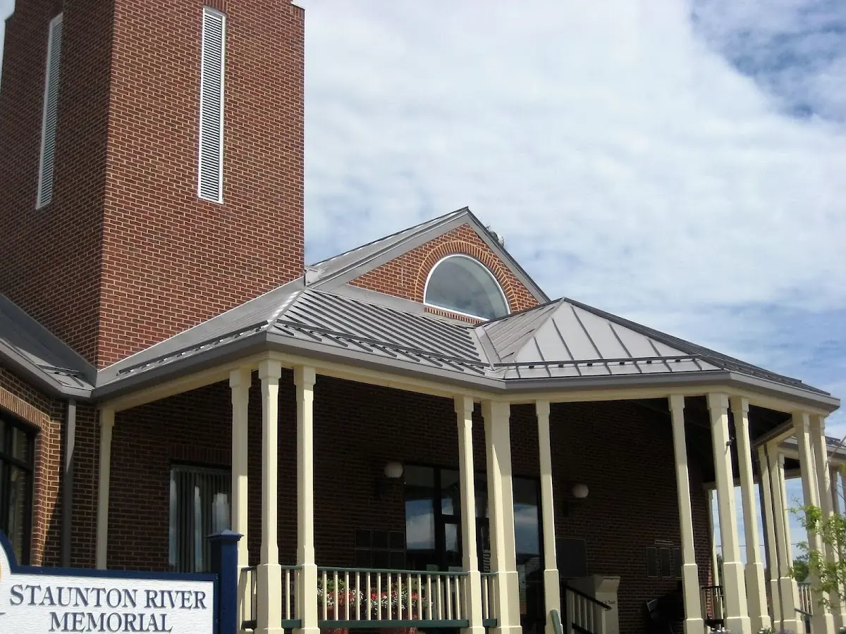 Skilled roofing craftsmen working on a residential roof in Etowah